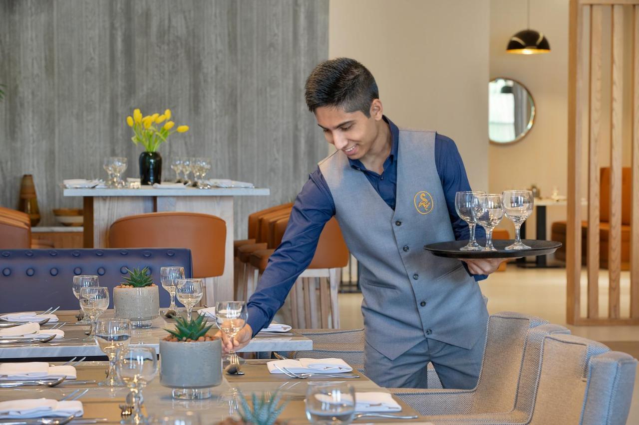 Voco Al Khobar By Ihg Hotel Exterior photo A waiter at work